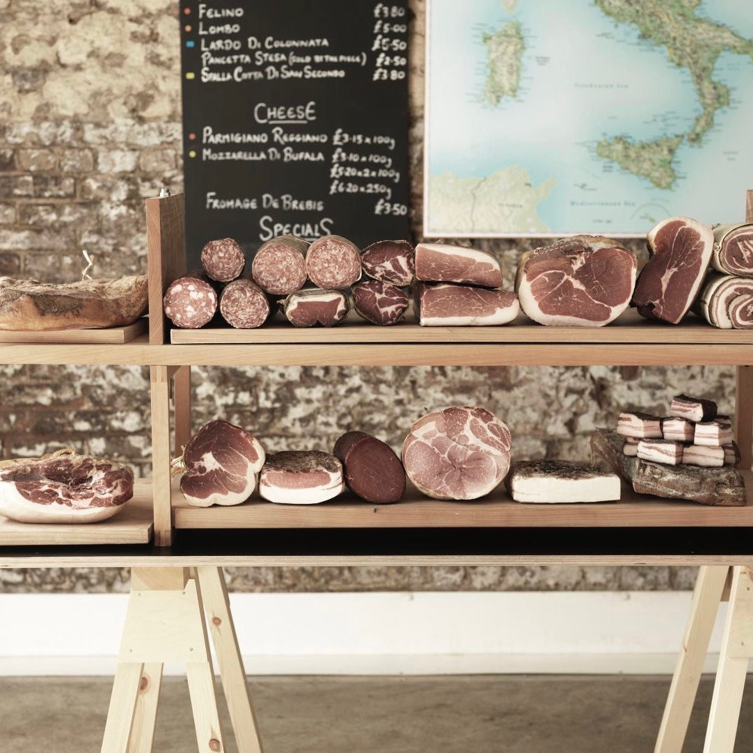 A selection of artisan salumi displayed on wooden boards at the Ham and Cheese Co Bermondsey store
